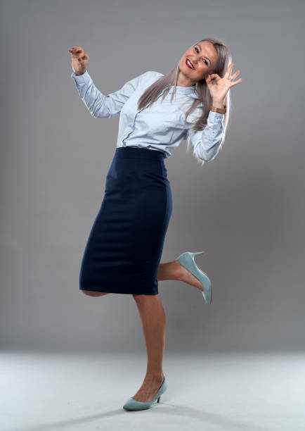 istock Successful businesswoman on gray 1285828635
