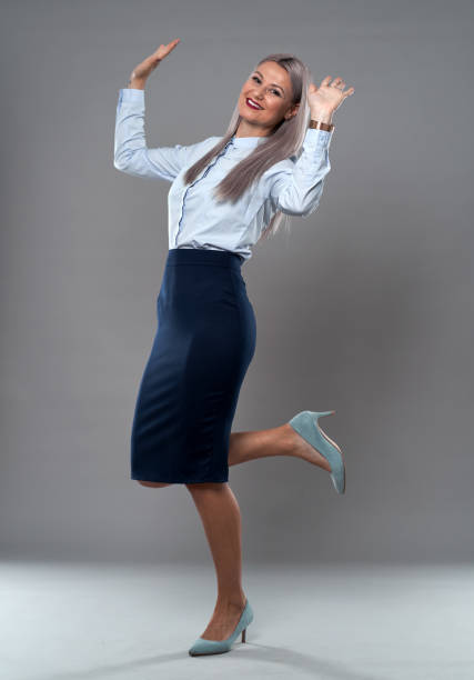 istock Successful businesswoman on gray 1285828646