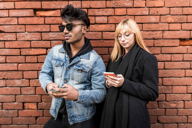 istock young multi-ethnic couple in front of brick wall 1285828648