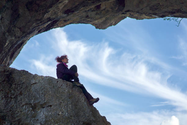 istock Woman hiker standing on the cliff in a doline 1285828827