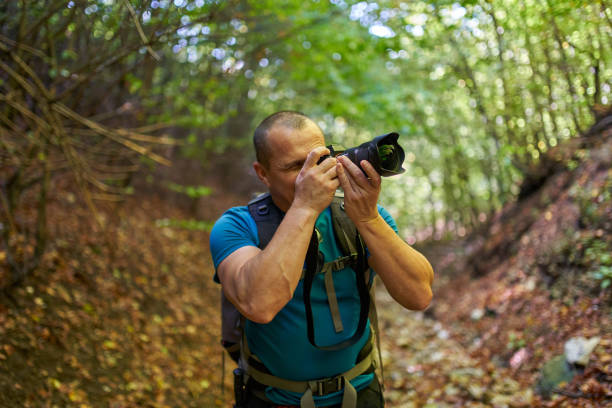 istock Nature photographer hiking into the forest 1285828887