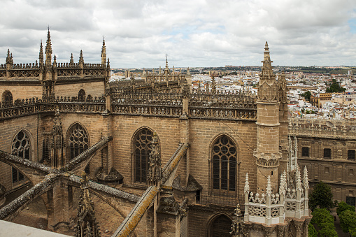 Seville, Spain - May, 8, 2019. View to Seville cathedral and the city from Giralda belfry, Spain. The cathedral is the biggest gothic and third Christian church of the world.