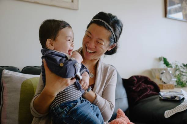istock Mother laughs with baby 1285832320