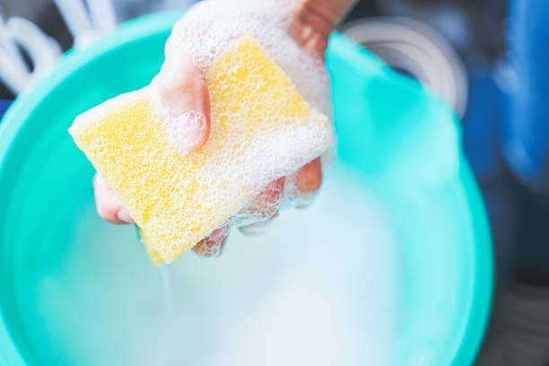 istock Squeezing Dishwashing Sponge, home sanitizing kitchen disinfectant, washing surfaces 1285833467
