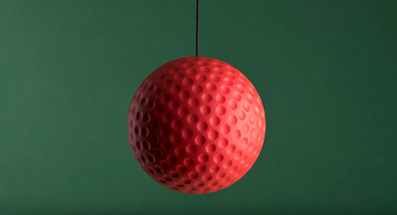 Red Ball Hang On Green Background