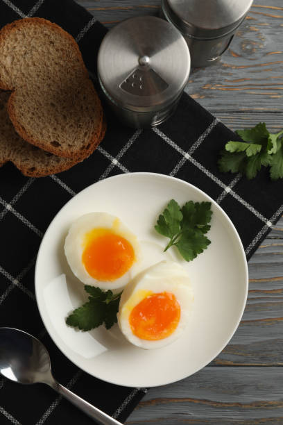 istock Concept of breakfast with boiled eggs on wooden background 1285833811