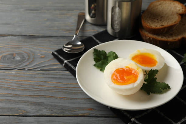istock Concept of breakfast with boiled eggs on wooden background 1285833833