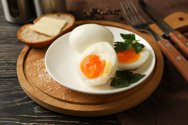 istock Concept of breakfast with boiled eggs on wooden background 1285833922
