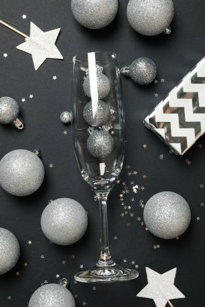 istock New year accessories and champagne glass on black background 1285836382