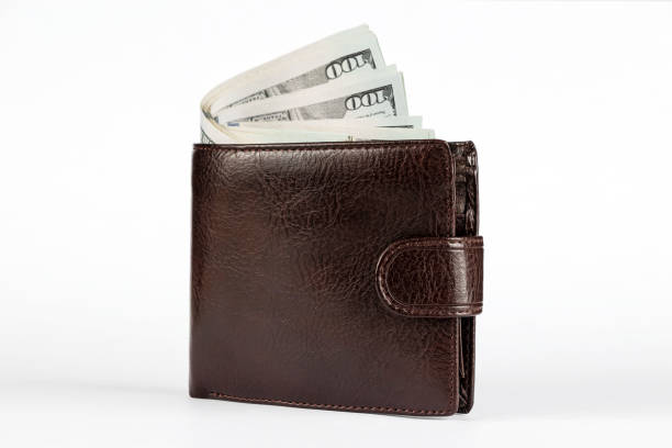 istock Brown wallet with dollars sticking out isolated on white background. 1285837148