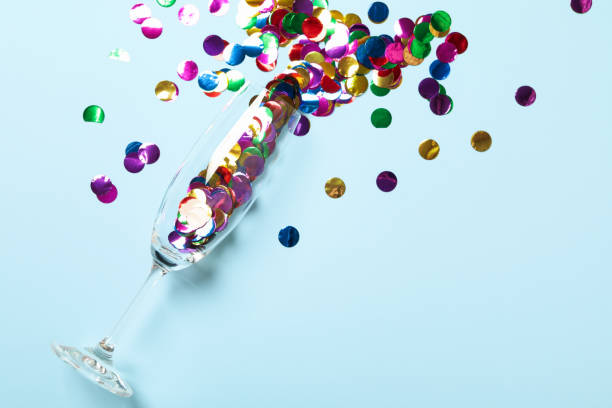 istock Champagne glass with glitter on blue background 1285837523