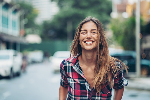 Smiling young woman outdoors in the city