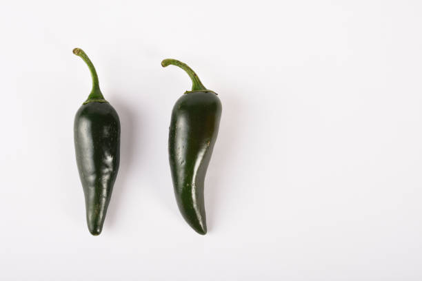 istock Green Jalapeno peppers on the white background 1285843126