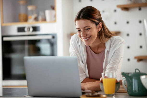 istock Beautiful woman having video call while eating the sandwich 1285844358