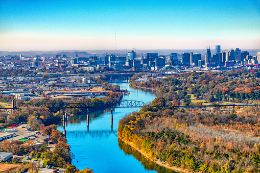 The skyline of beautiful Nashville, Tennessee, in the distance along the banks of the Cumberland River.