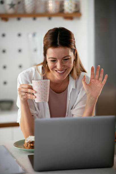 istock Beautiful woman having video call while eating the sandwich 1285845244