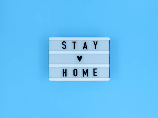 istock Light box with Stay home quote on a blue background. 1285845379