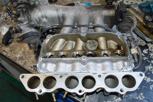 The removed intake manifold of the car engine is on the desktop The removed intake manifold of a V6 petrol car engine with broken air dampers lies on the desktop throttle photos stock pictures, royalty-free photos & images
