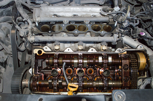 V6 petrol internal combustion engine with valve cover and intake manifold removed