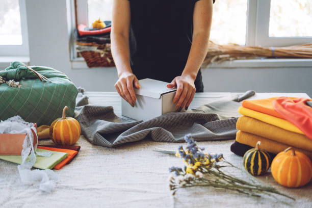 istock Furoshiki Japanese Gift Wrapping. Thanksgiving Zero waste, eco-friendly gift wrapping process, tutorial. Fall hand-wrapped gift in traditional Japanese Furoshiki style 1285846573
