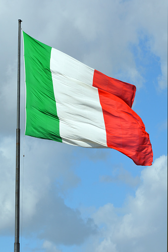 Italian national flag before the Railway station in Florence - Italy.