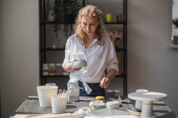 istock Production process of pottery. Application of glaze brush on ceramic ware 1285853143