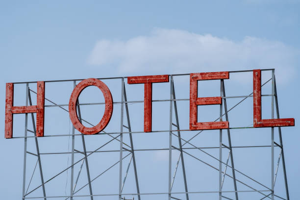 istock Generic red neon sign for a hotel, against a blue sky 1285855414