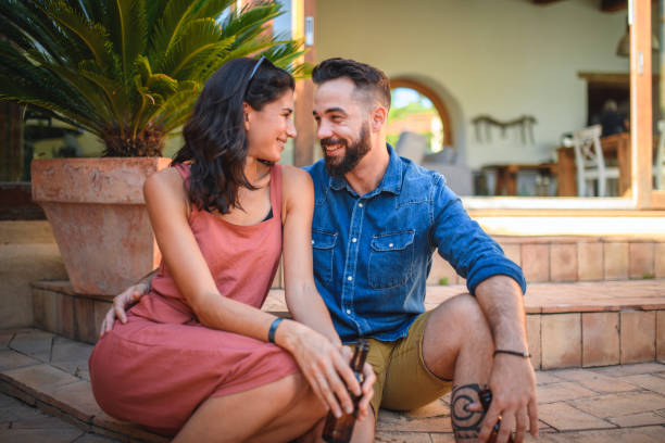 istock Smiling Spanish Couple Face to Face on Outdoors Steps 1285857157