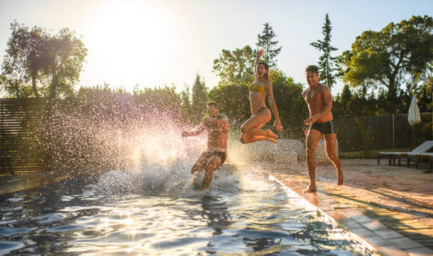 Friends Running and Jumping into Swimming Pool