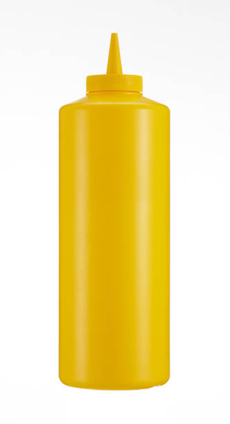Close-up of yellow mustard bottle on a white background