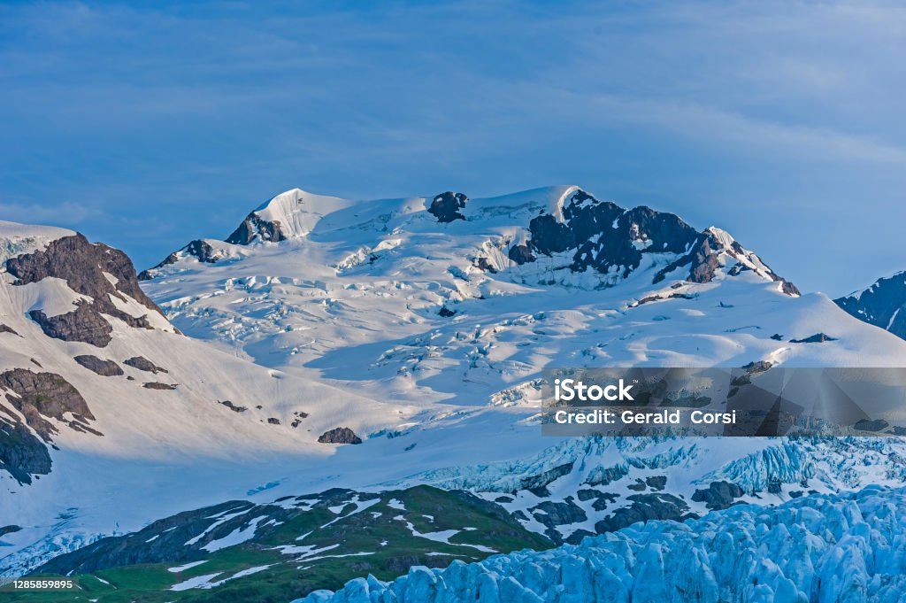 T he head of a glacier in the Chugach Mountains, Prince William Sound, Alaska. Arete, horn and crevasse Alaska - US State Stock Photo
