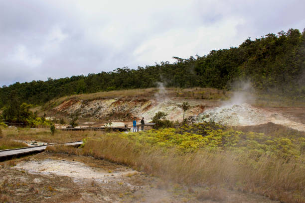 Tourists view the Sulphur banks that can be found walking along the boardwalk in Volcanoes National Park stock photo
