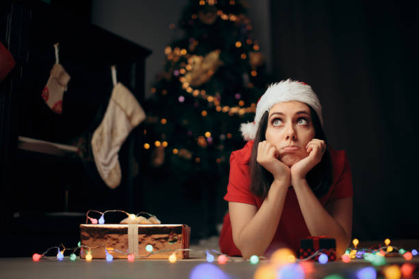 istock Sad Stressed Woman Thinking under the Christmas Tree 1285862797