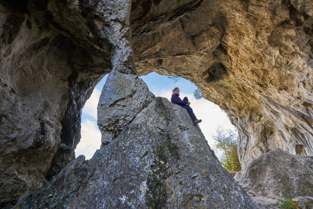 istock Woman hiker standing on the cliff in a doline 1285865573