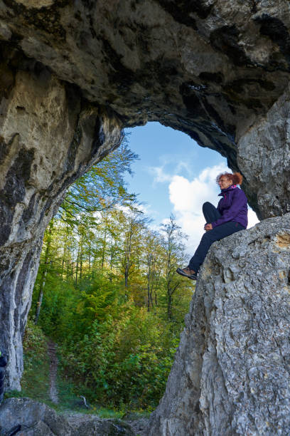 istock Woman hiker standing on the cliff in a doline 1285865574
