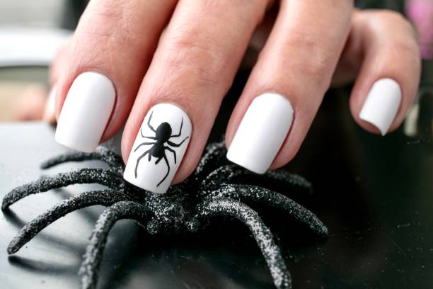 Black Spider Nail Art Design Halloween Inspired Art fall nail art stock pictures, royalty-free photos & images