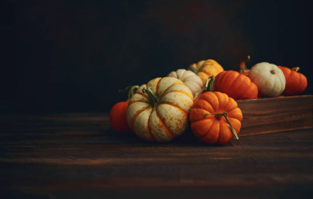 istock Thanksgiving Fall arrangement with pumpkins in harvest crate 1285866383