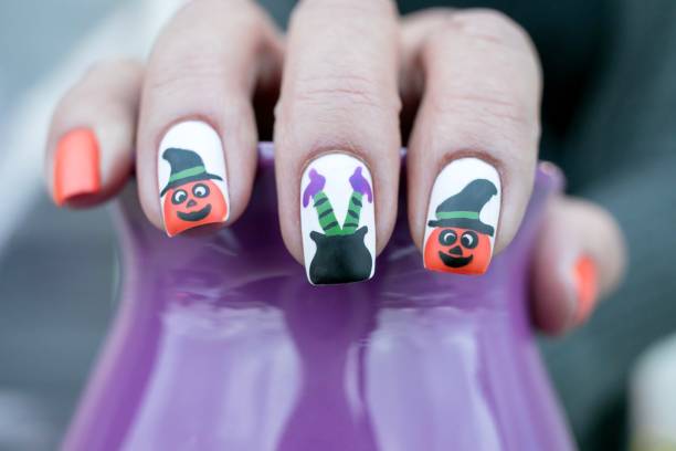 istock Pumpkin and Witch Legs Nail Art Design 1285866388