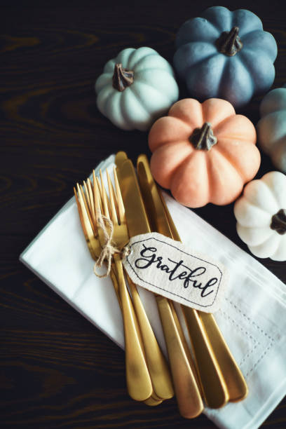istock Thanksgiving Table Setting Background with Pumpkins and Gold Cutlery. Grateful 1285868821