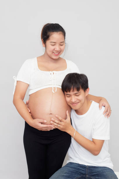 istock A happy family expecting a baby on a white background 1285871028