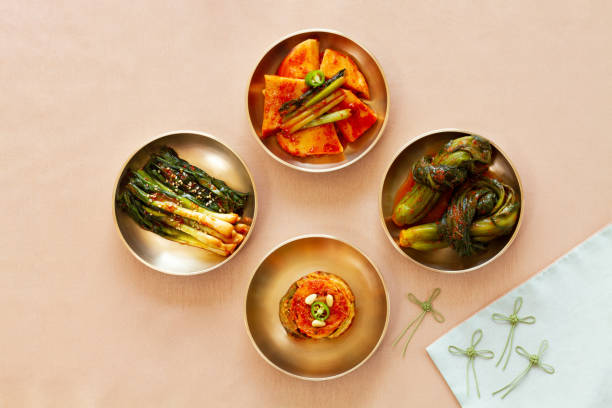 The most famous Korean food Kimchi set(napa cabbage, leaf mustard, turnip, green onion) in high quality brass tableware. Top view. The most famous Korean food Kimchi set(napa cabbage, leaf mustard, turnip, green onion) in high quality brass tableware. Top view. Kimchi stock pictures, royalty-free photos & images