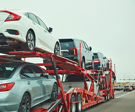 October 18, 2020 - Colorado Springs, Colorado, USA: A car transporter carries a variety of vehicles on State Highway 21 in Colorado on a foggy October morning