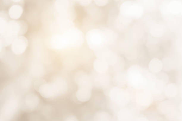 cream blurred christmas lights background. design effect focus happy holiday party glow texture white wallpaper bokeh sun sunny star shiny soft plain warm flare blur night light new year. - bege imagens e fotografias de stock