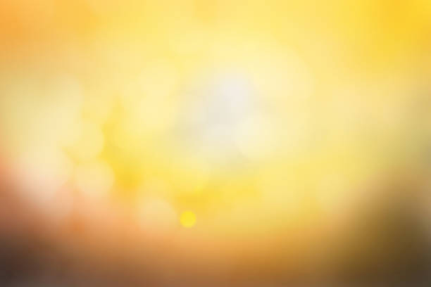 istock Hope concept; Abstract blurred sunrise background blurring warm colors calm bright sunlight. Sky effect gradient white sun at color orange light yellow soft flare patterns blur plain morning summer. 1285876418