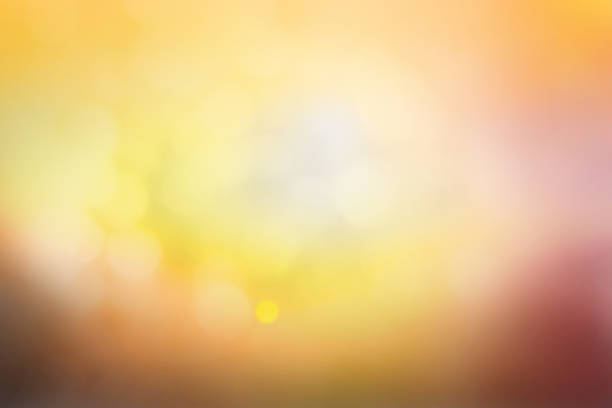 istock Hope concept; Abstract blurred sunrise background blurring warm colors calm bright sunlight. Sky effect gradient white sun at color orange light yellow soft flare patterns blur plain morning summer. 1285877213