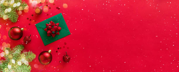 istock Christmas letter with greeting card and congratulations, christmas tree branches, baubles, glitter decorations on red. Merry Christmas happy New Year concept. Flat lay, banner, copy space 1285878088