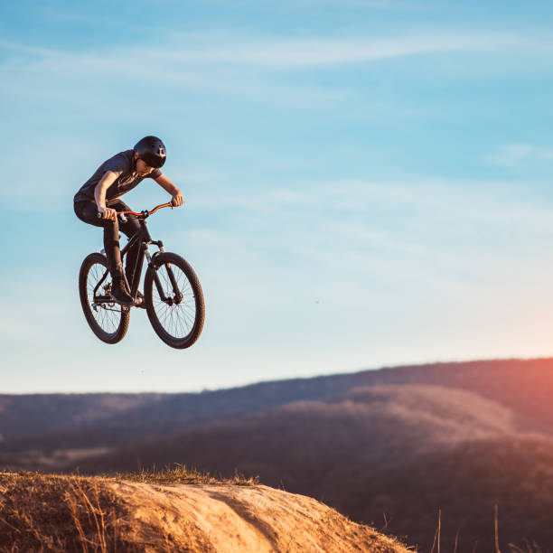 istock Young man flying through the air on a mountain bike 1285880714