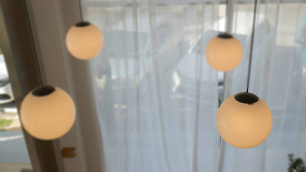 istock Lamp hanging in a dark room 1285881084
