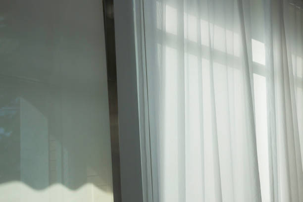 istock Soft curtain in modern white room 1285881100