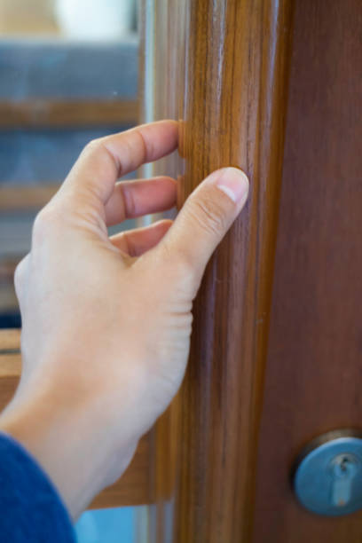 istock Hand on opening a wooden door 1285881105